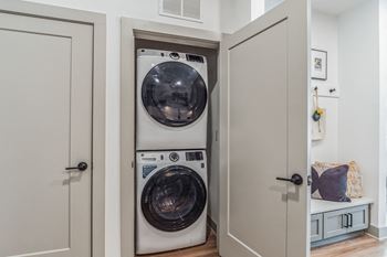 A small laundry room with a washer and a dryer